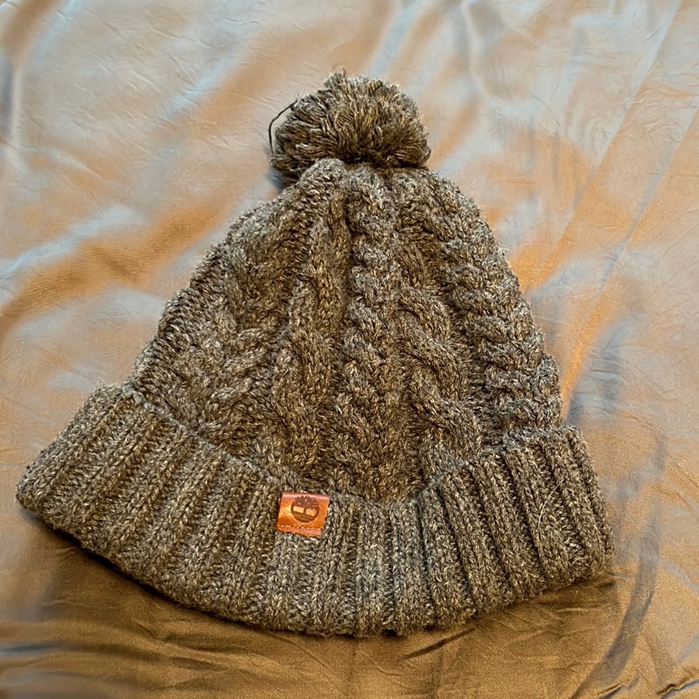 Grey winter hat with pompon